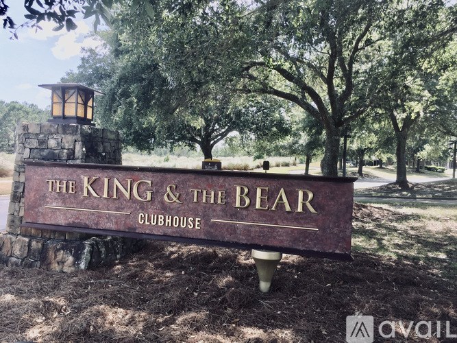 A sign for "The King & The Bear Clubhouse" is displayed in front of trees.