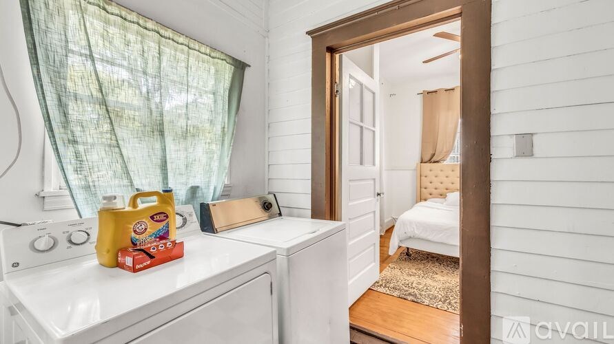 A yellow detergent box sits on a white washing machine.