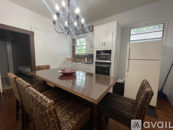 A dining room with a wooden table and chairs.