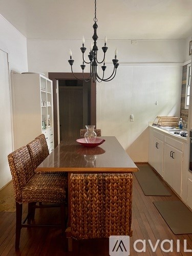 A dining room with a wooden table and chairs.
