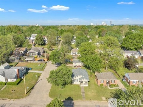 A bird's eye view of a residential area with houses and trees.