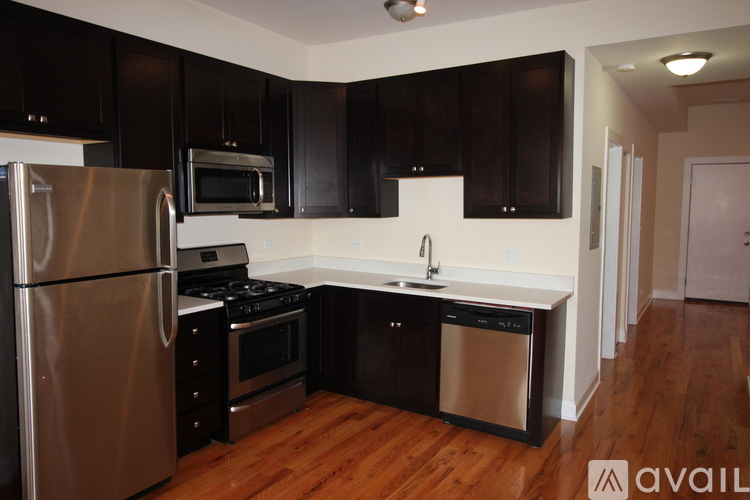 A kitchen with black cabinets and stainless steel appliances.