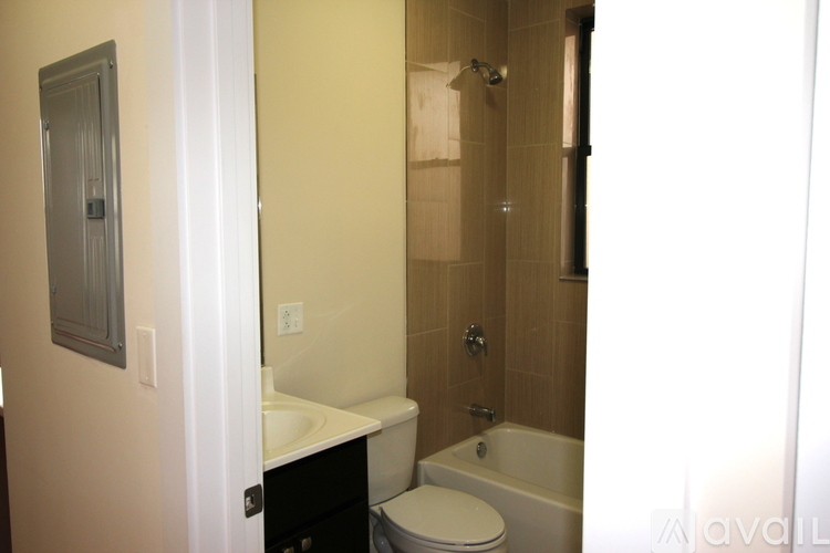A bathroom with a toilet, sink, and shower.