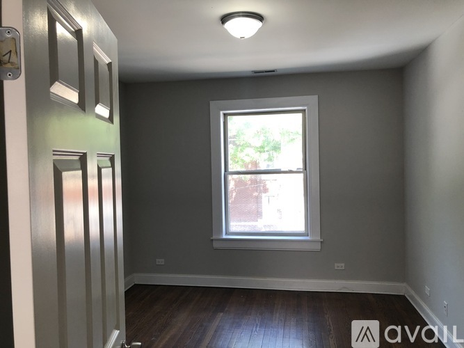 A room with a window and a door.