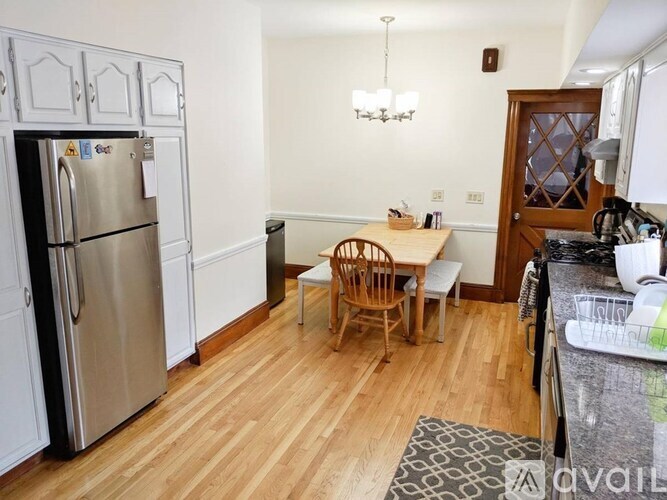 A kitchen with a table and chairs in the middle of the room.