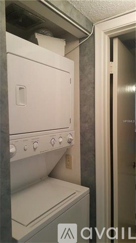 A white oven and stove top are installed in a small kitchen.