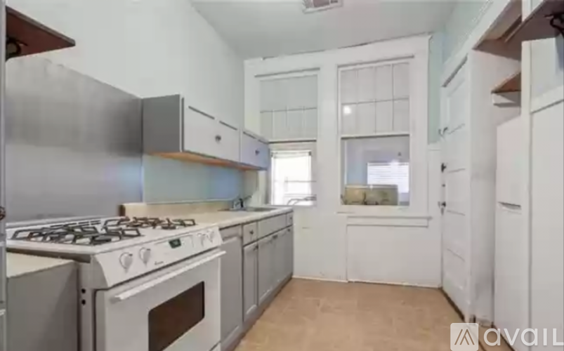 A kitchen with a stove, oven, and cabinets.
