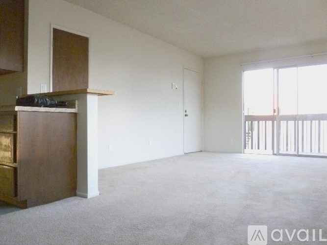 A living room with a fireplace and a carpeted floor.