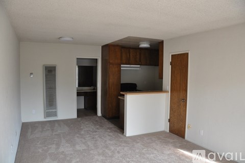A living room with a white couch and a television.