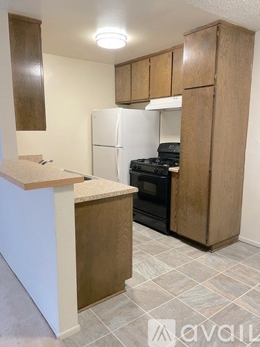 A kitchen with a white refrigerator and a white oven.