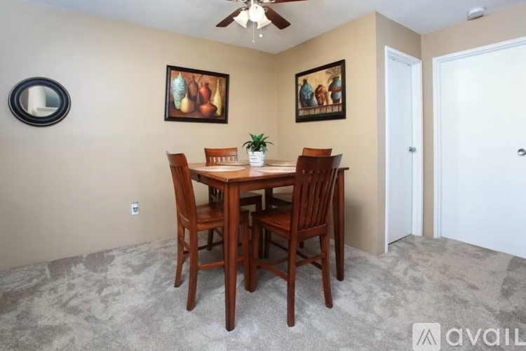 A dining room with a table and chairs.