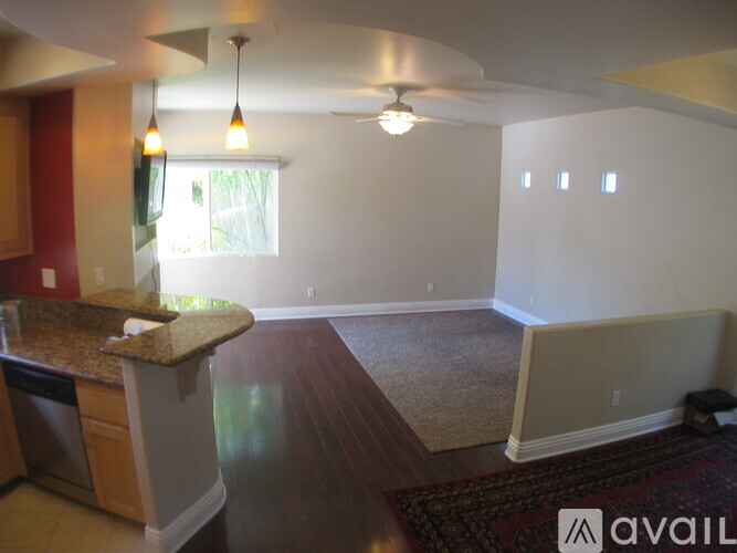 A kitchen with a granite countertop and a ceiling fan.