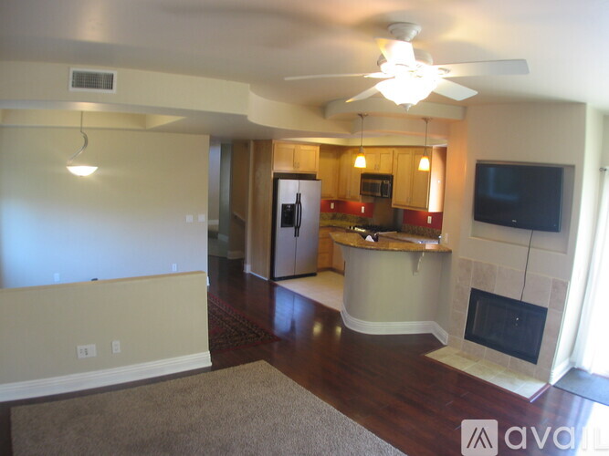 A living room with a fireplace and a television.