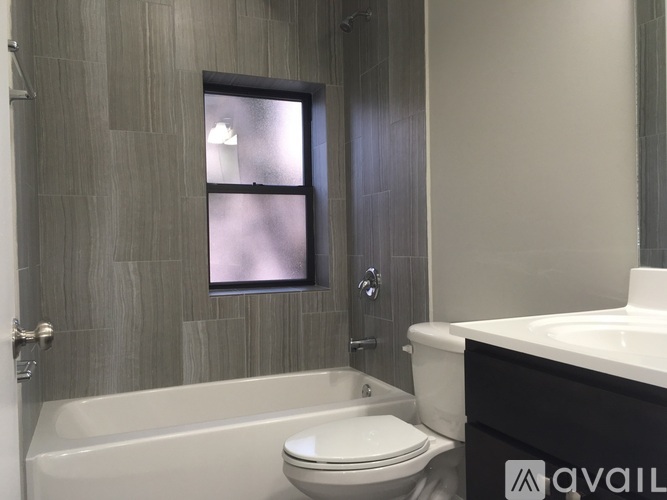 A bathroom with a tub, toilet and sink.