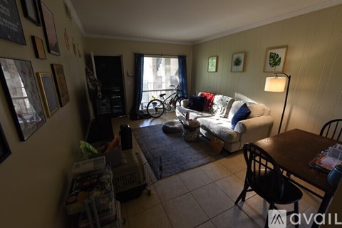 A living room with a white couch and a black chair.