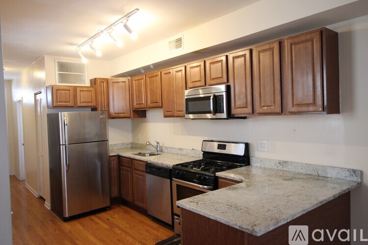 A kitchen with wooden cabinets and stainless steel appliances.
