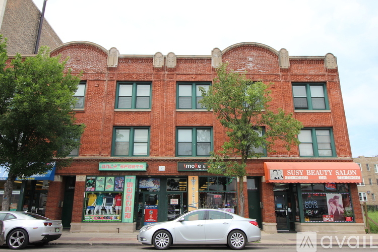 A red brick building with a Susy Beauty Salon on the ground floor.