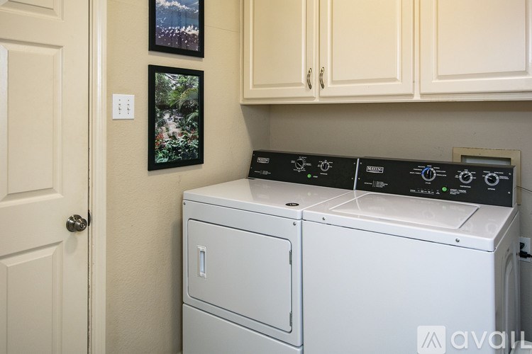 A white washer and dryer in a laundry room.