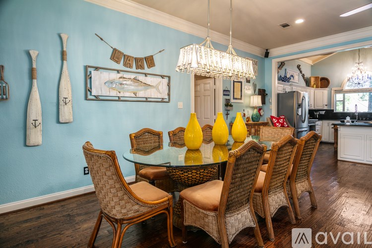 A dining room with a glass table and chairs.