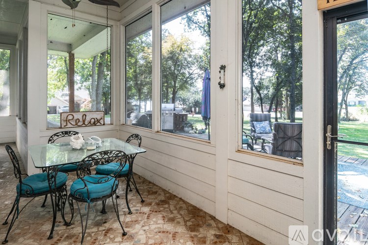 A patio with a glass table and chairs with a sign that says "Pellet".