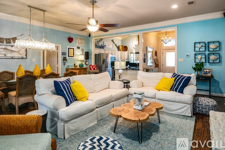 A living room with a white couch and a wooden coffee table.
