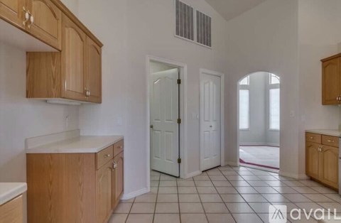 A kitchen with wooden cabinets and a white countertop.