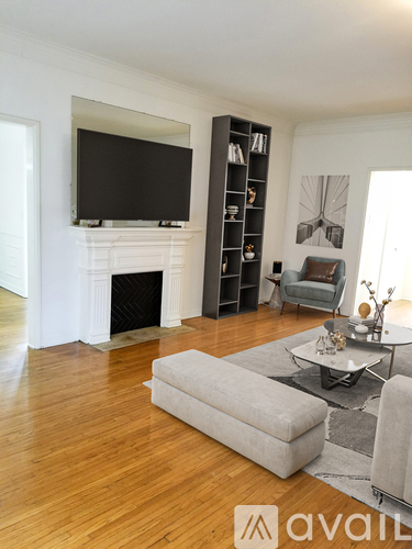 A living room with a fireplace and a television on the wall.