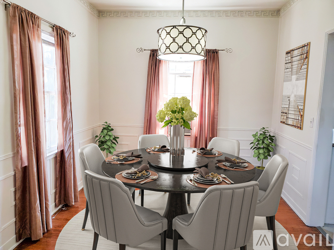 A dining room with a round table set for six.