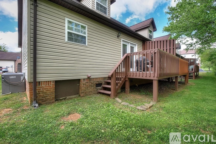 A house with a deck and a hot tub.