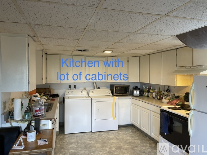 A kitchen with a lot of cabinets and appliances.