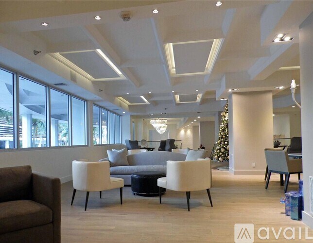 A living room with a Christmas tree and a couch.