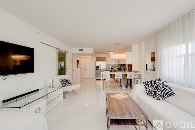 A modern living room with a white couch and a glass coffee table.