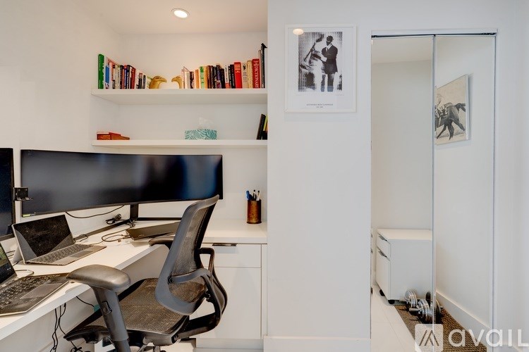 A modern home office with a desk, chair, and computer.