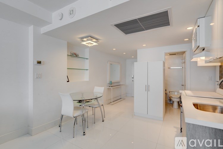 A modern kitchen with a dining table and chairs.