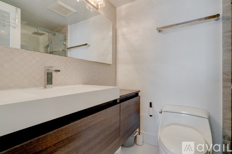 A white toilet sits next to a sink in a bathroom.