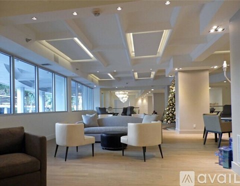 A living room with a Christmas tree and a couch.