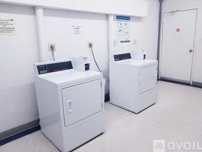 Two white appliances in a room with a sign on the wall.