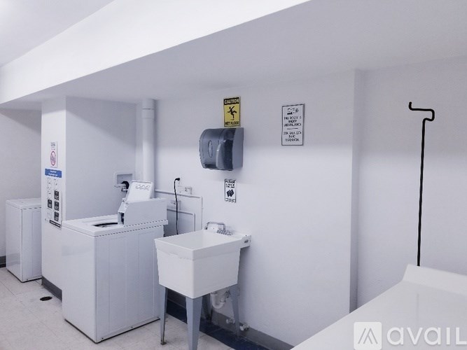 A white room with a sink and a machine.