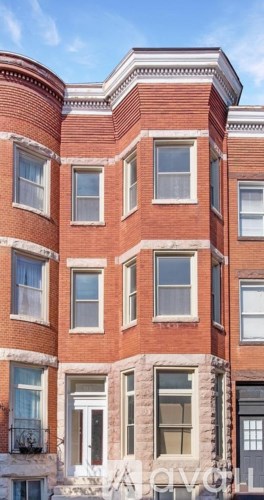 A red brick building with white trim and windows.