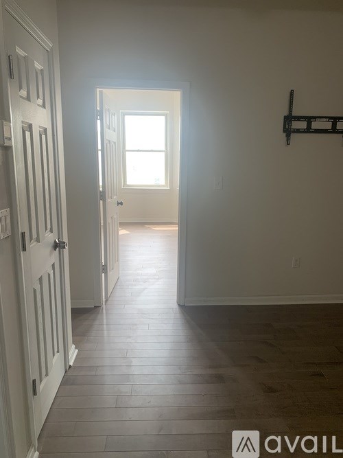 A long hallway with a door at the end.