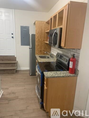 A kitchen with wooden cabinets and a granite countertop.