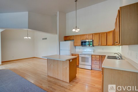 A kitchen with wooden cabinets and a white refrigerator.