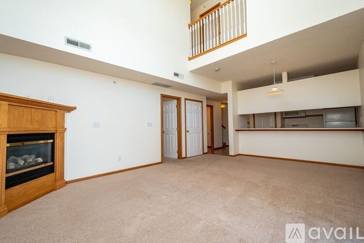 A living room with a fireplace and a carpeted floor.
