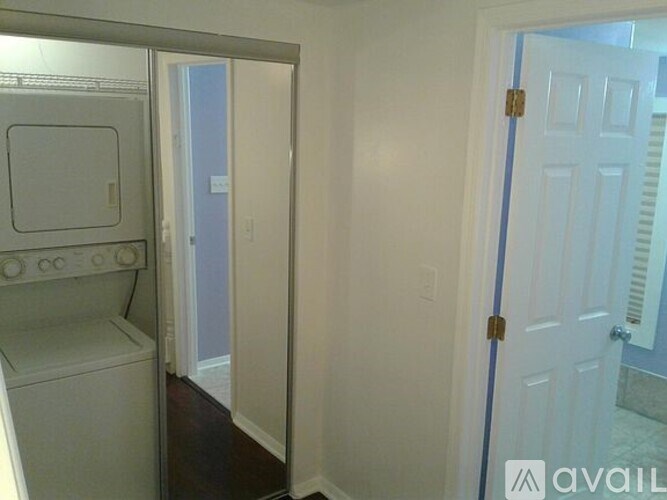 A small laundry room with a washer and dryer.
