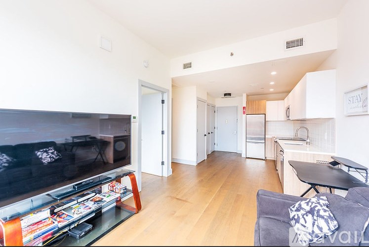 A living room with a television and a couch.