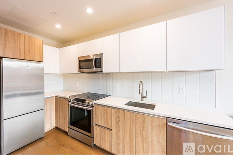 A kitchen with wooden cabinets and stainless steel appliances.