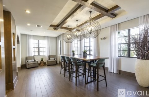 A spacious dining area with a large table and chairs.