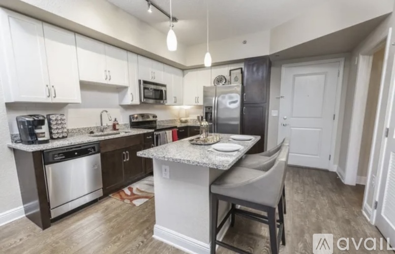 A kitchen with a table and chairs in the middle of it.