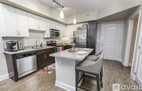 A kitchen with a table and chairs in the middle of it.