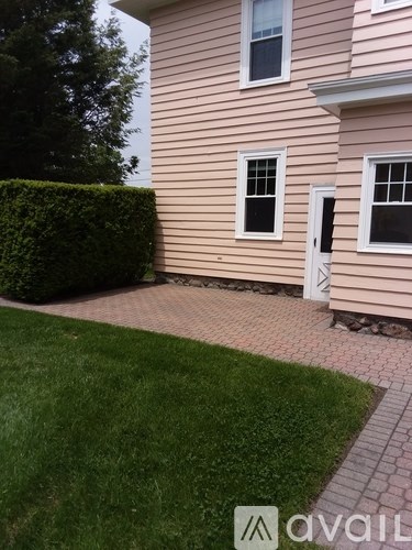 A house with a pink siding and a white door.